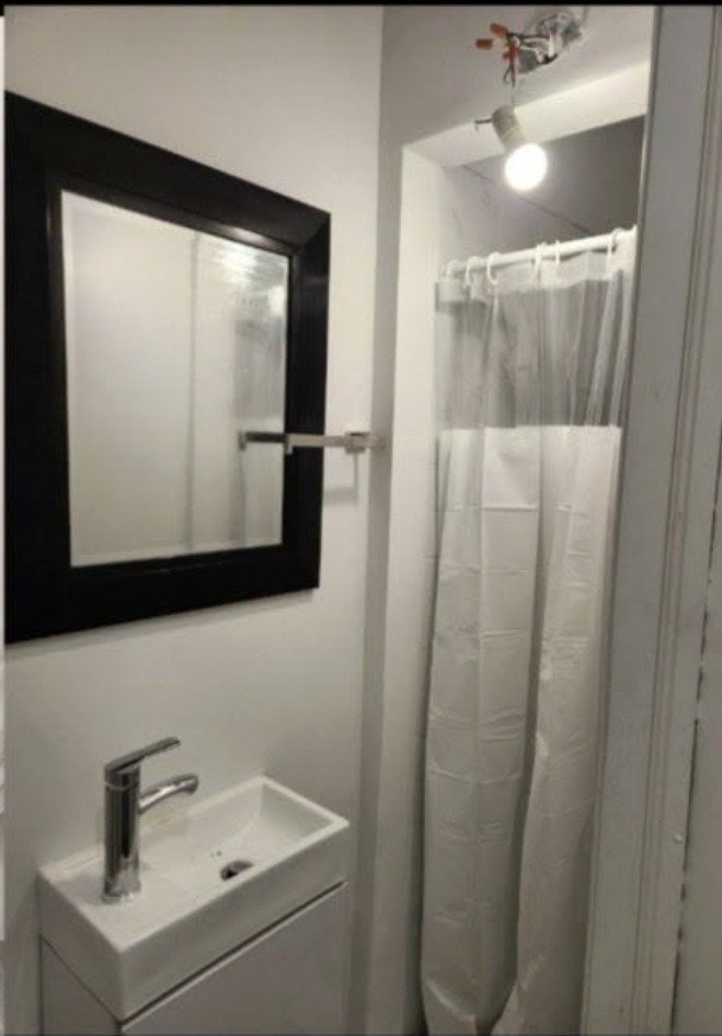 After: finished bathroom with vanity, mirror and shower completed by Pioneer Plumbing & Home Services